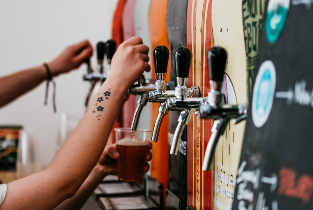 pouring beers at a brewery in nelson